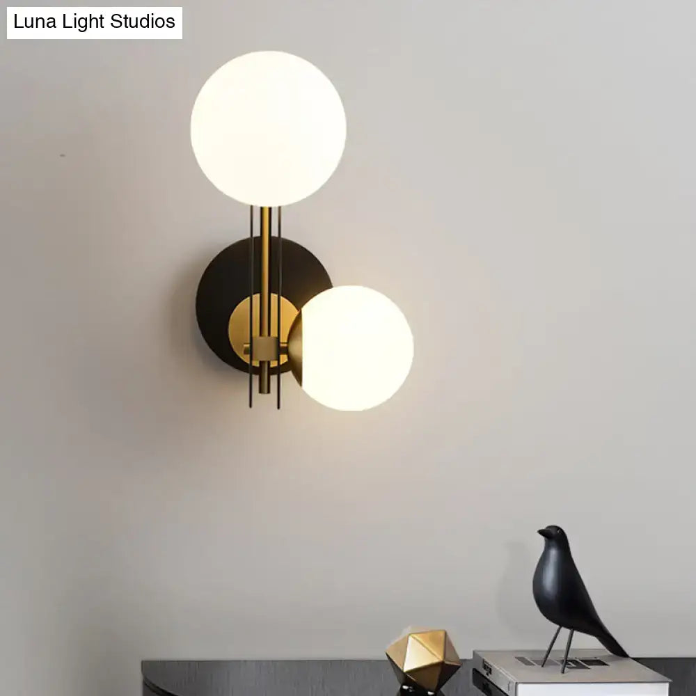 Black Gold Wired Glass Light sconce with two globes, black backplate and brass stems on Tampa Home & Garden Store