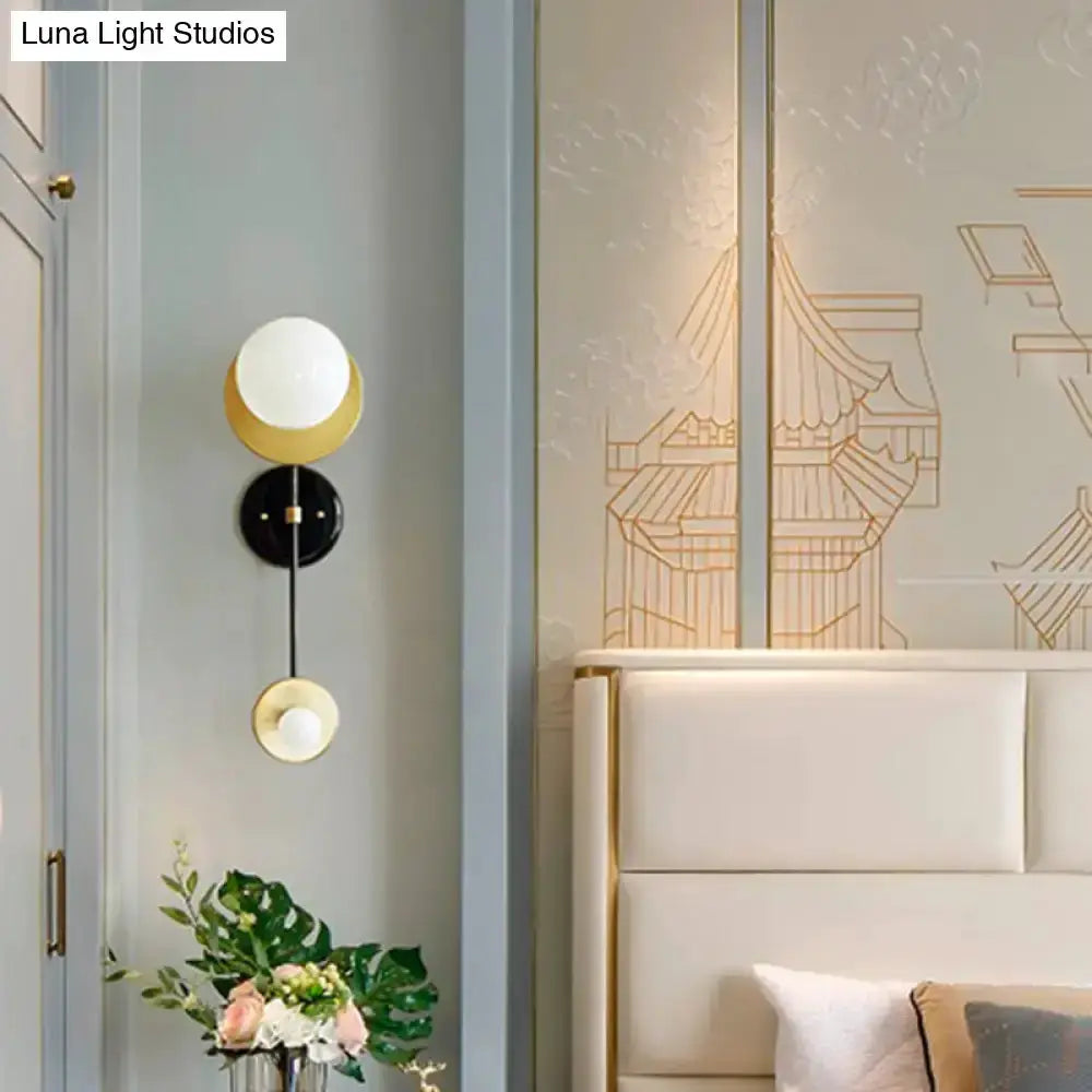Modern black and gold opal glass wall sconce by Decorbites with two globe shades brass accents on Tampa Home & Garden Store