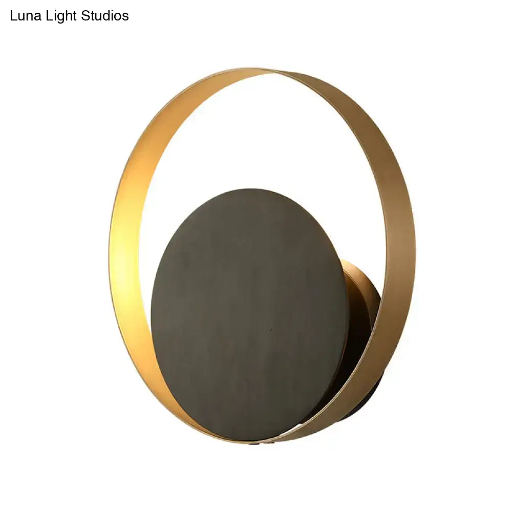 Gold orbit sconce light featuring a circular gold ring and matte black backplate Decorbites on Tampa Home & Garden Store