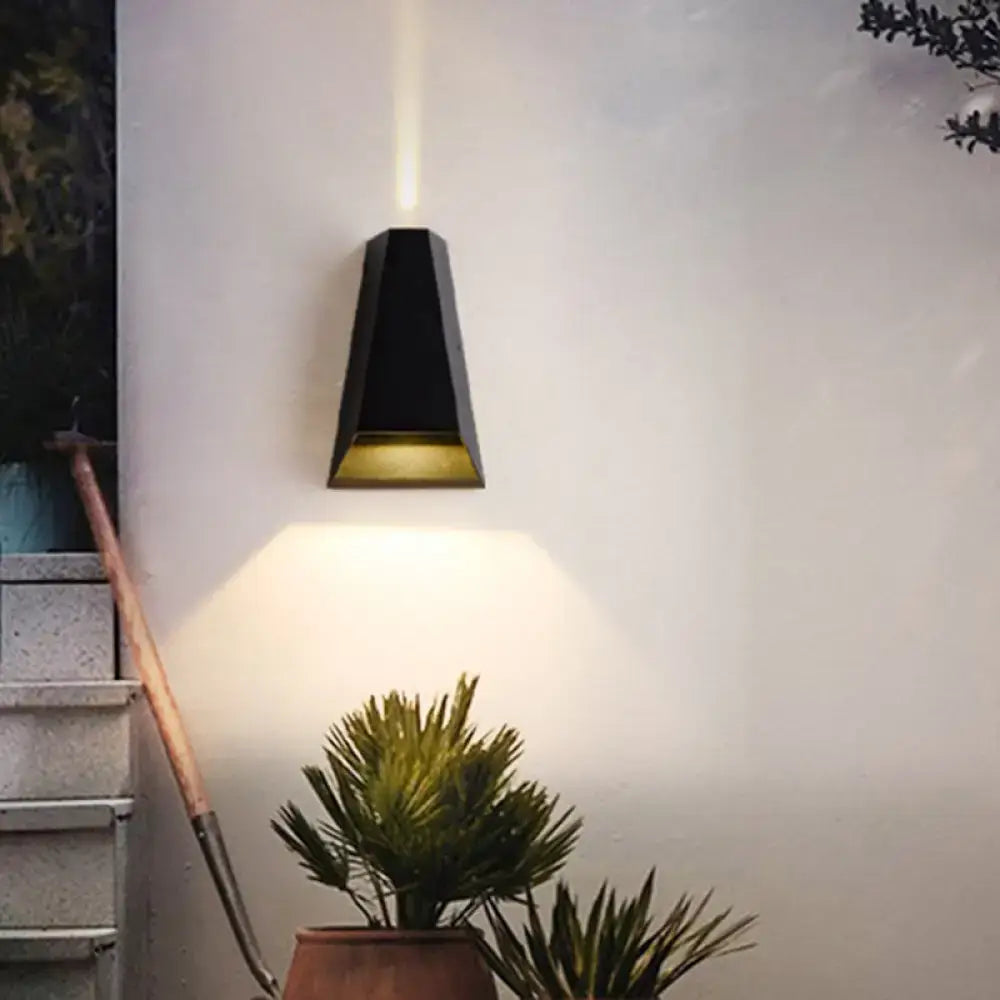 Triangle aluminum LED wall sconce in black with a triangular silhouette and warm downlight on Tampa Home & Garden Store