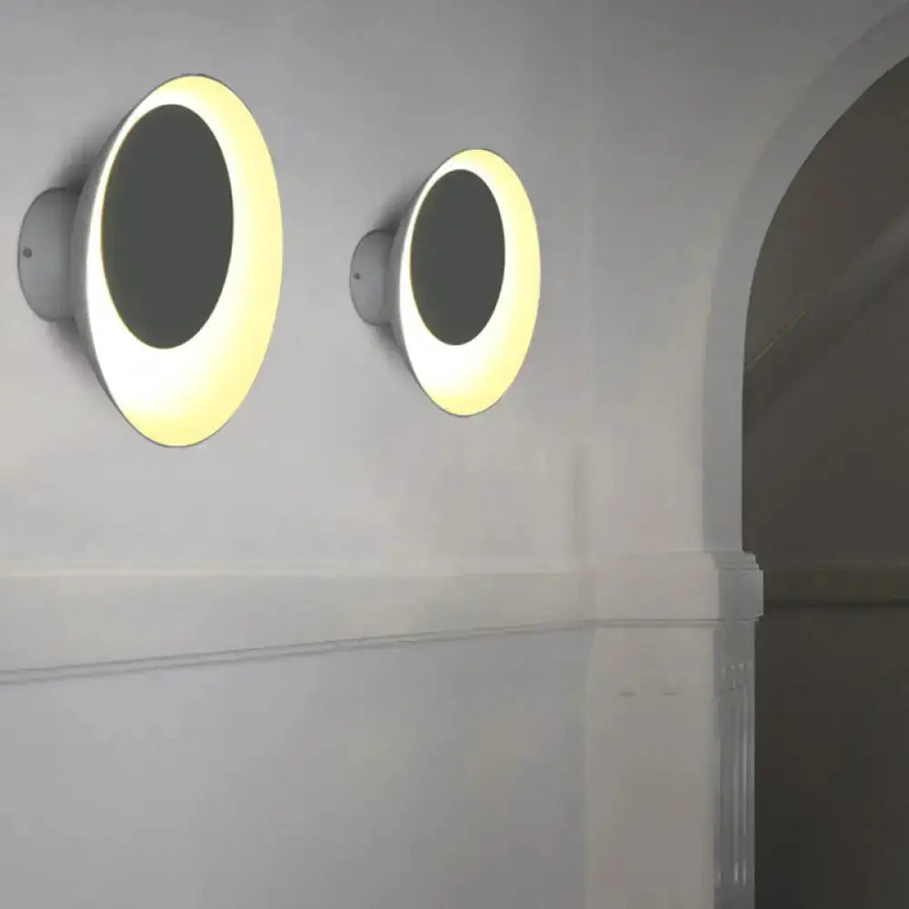 Two modern circular wall sconces with illuminated white rings for bedroom decor on Tampa Home & Garden Store