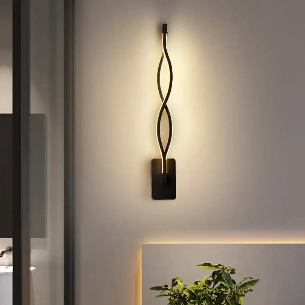 Black Twisted LED Sconce by Decorbites; wall-mounted black metal lamp with warm glow on Tampa Home & Garden Store