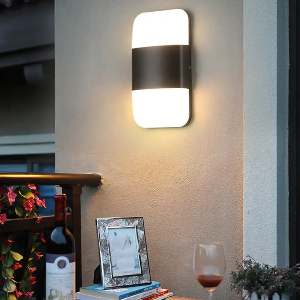 Black rectangle cast iron wall sconce with two white illuminated panels warm glow on Tampa Home & Garden Store