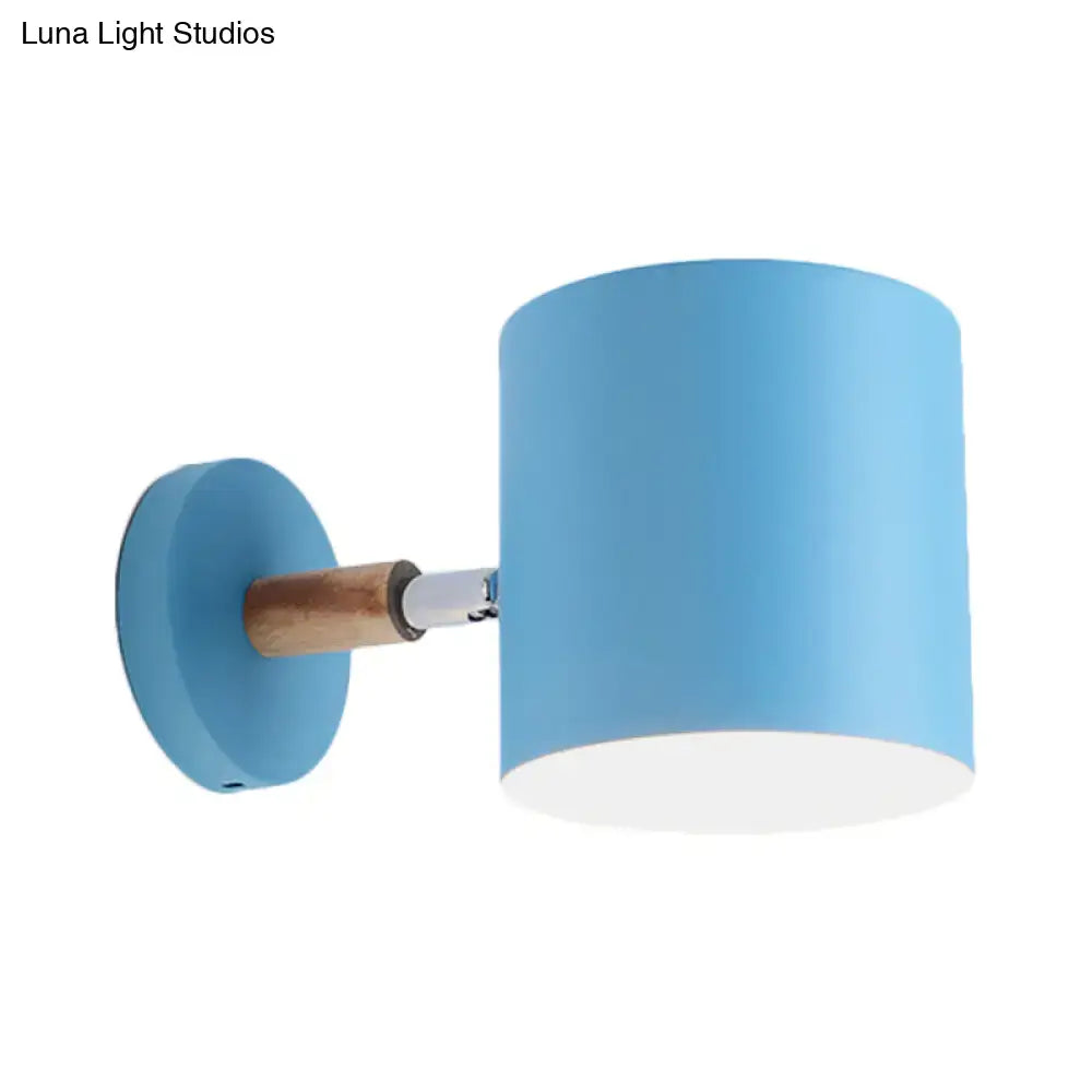 Blue tubular wall sconce by Decorbites with cylindrical shade and wood arm on Tampa Home & Garden Store
