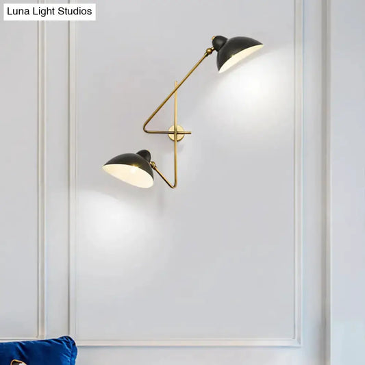 Brass and black dual-arm duckbill wall sconce with adjustable shades on white wall on Tampa Home & Garden Store