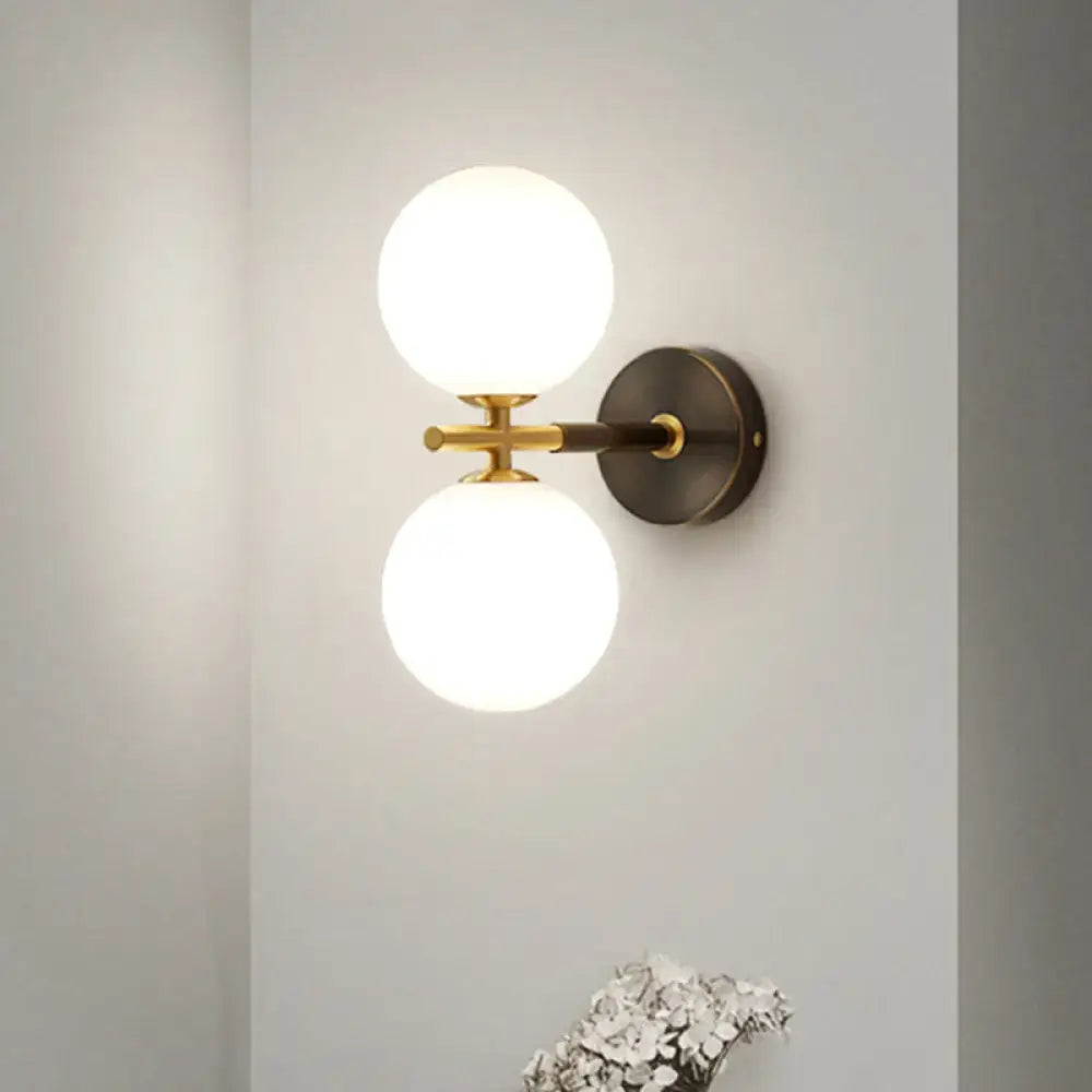 Brass glass globe double wall sconce with round backplate by Decorbites on Tampa Home & Garden Store