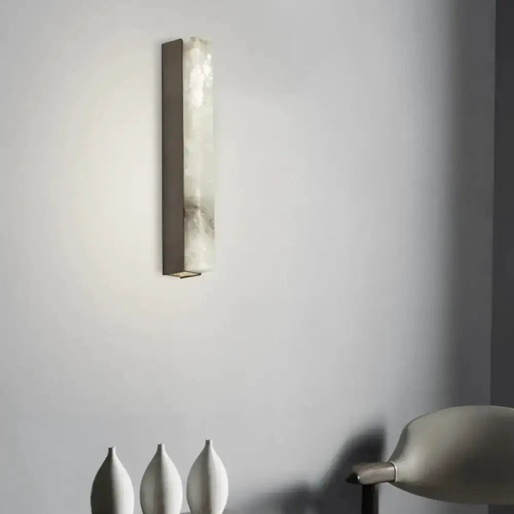 Modern brass and white onyx wall sconce by Decorbites, vertical brass frame with white onyx panel on Tampa Home & Garden Store
