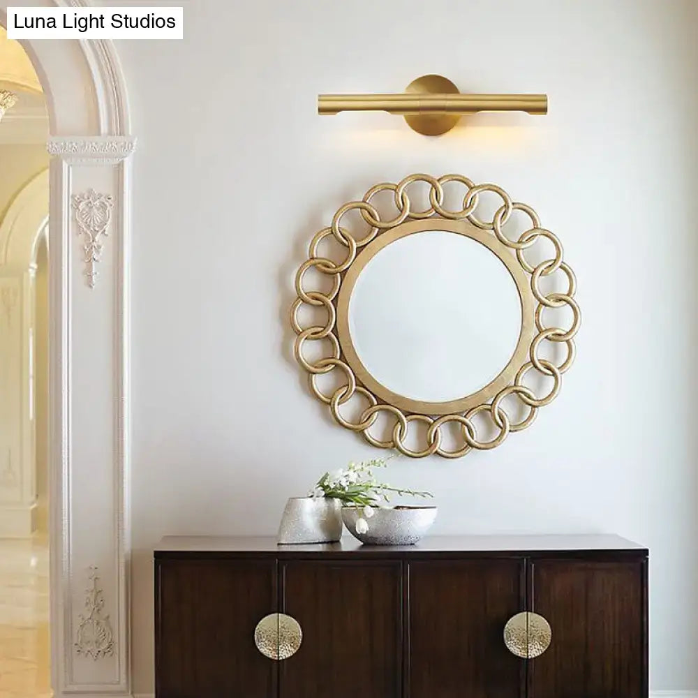 Brass Tube Vanity Light by Decorbites with gold finish above a round linked-ring mirror on Tampa Home & Garden Store