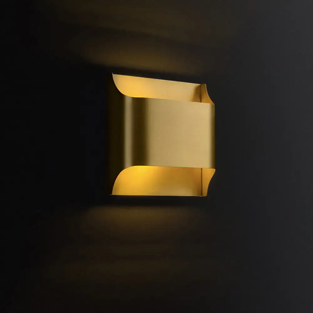 Brass Geometric Wall Sconce by Decorbites, brass fixture with curved cutouts and warm glow on Tampa Home & Garden Store