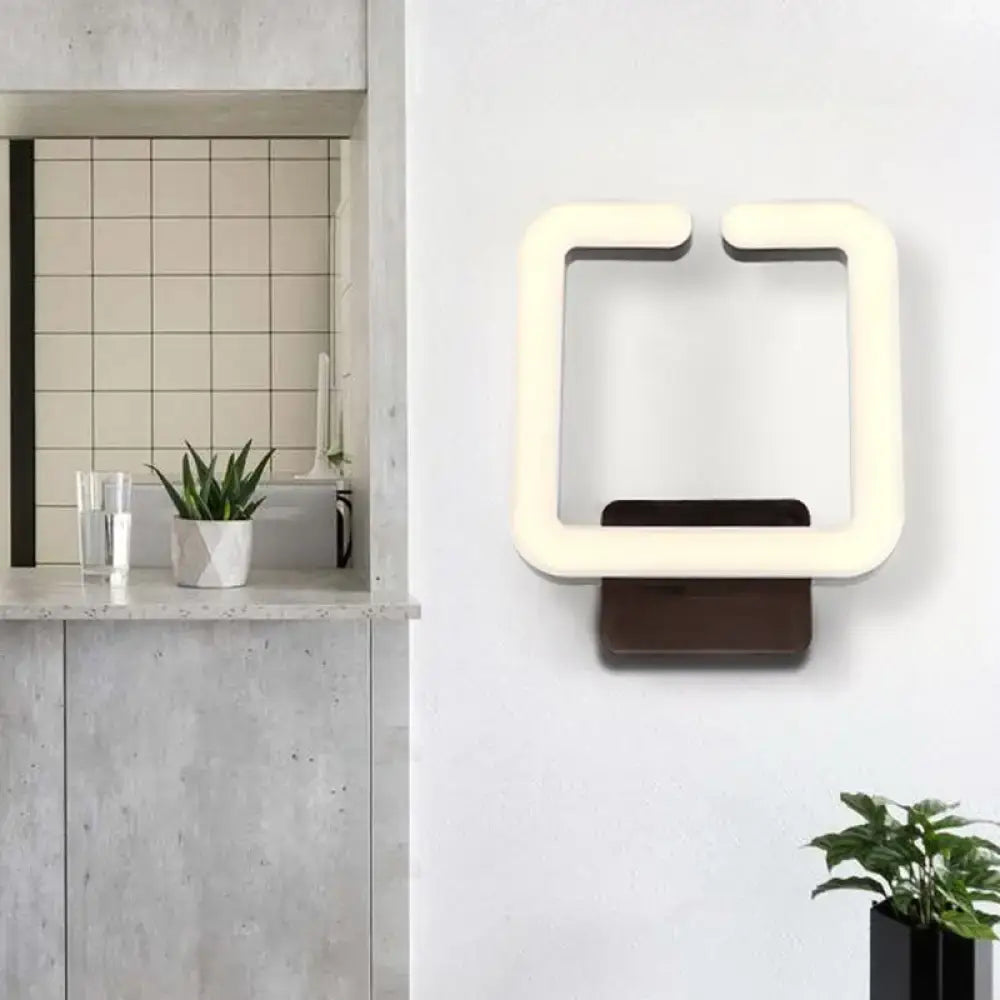 Cream square wall sconce with glowing LED frame, modern Decorbites lighting on Tampa Home & Garden Store