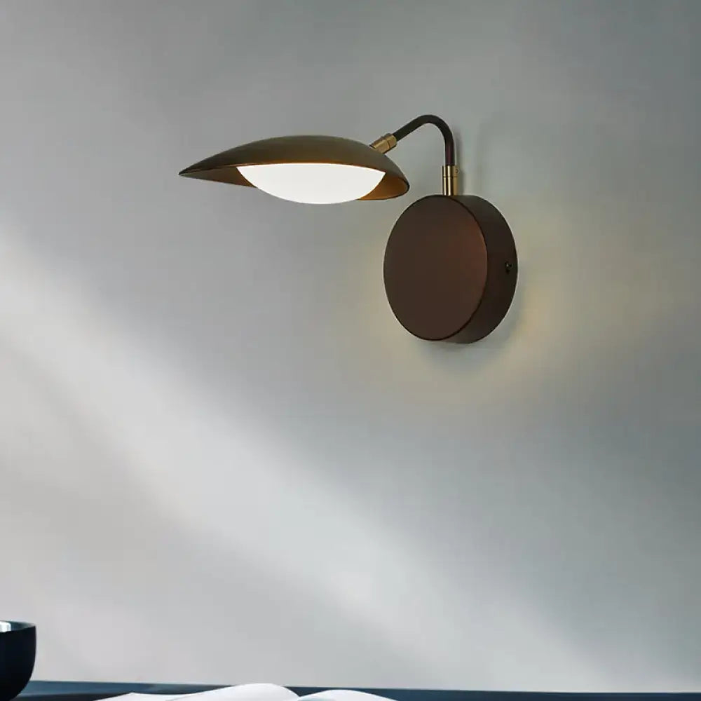 Bronze Oval Wall Sconce by Decorbites with round backplate and curved arm, warm LED shade on Tampa Home & Garden Store