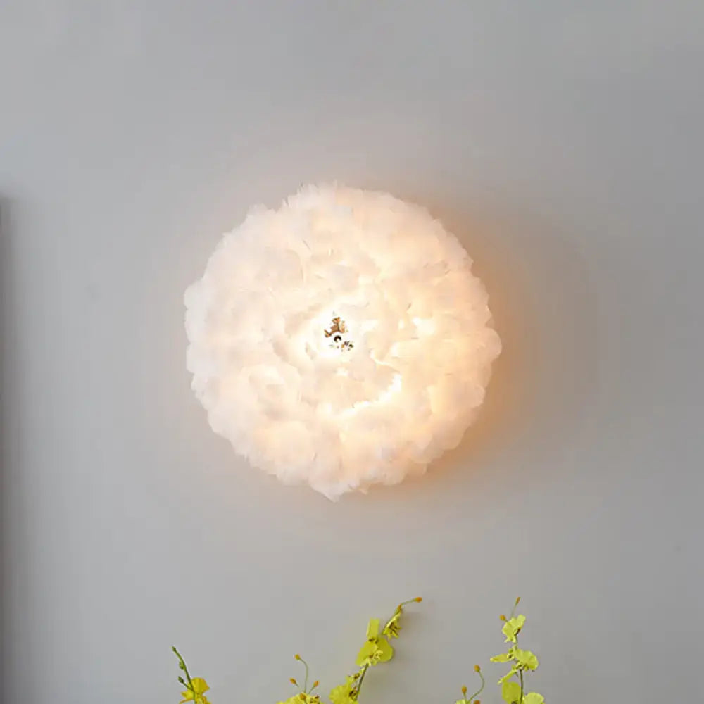 Grey Feather Wall Sconce by Decorbites with round feather shade and warm glow on Tampa Home & Garden Store