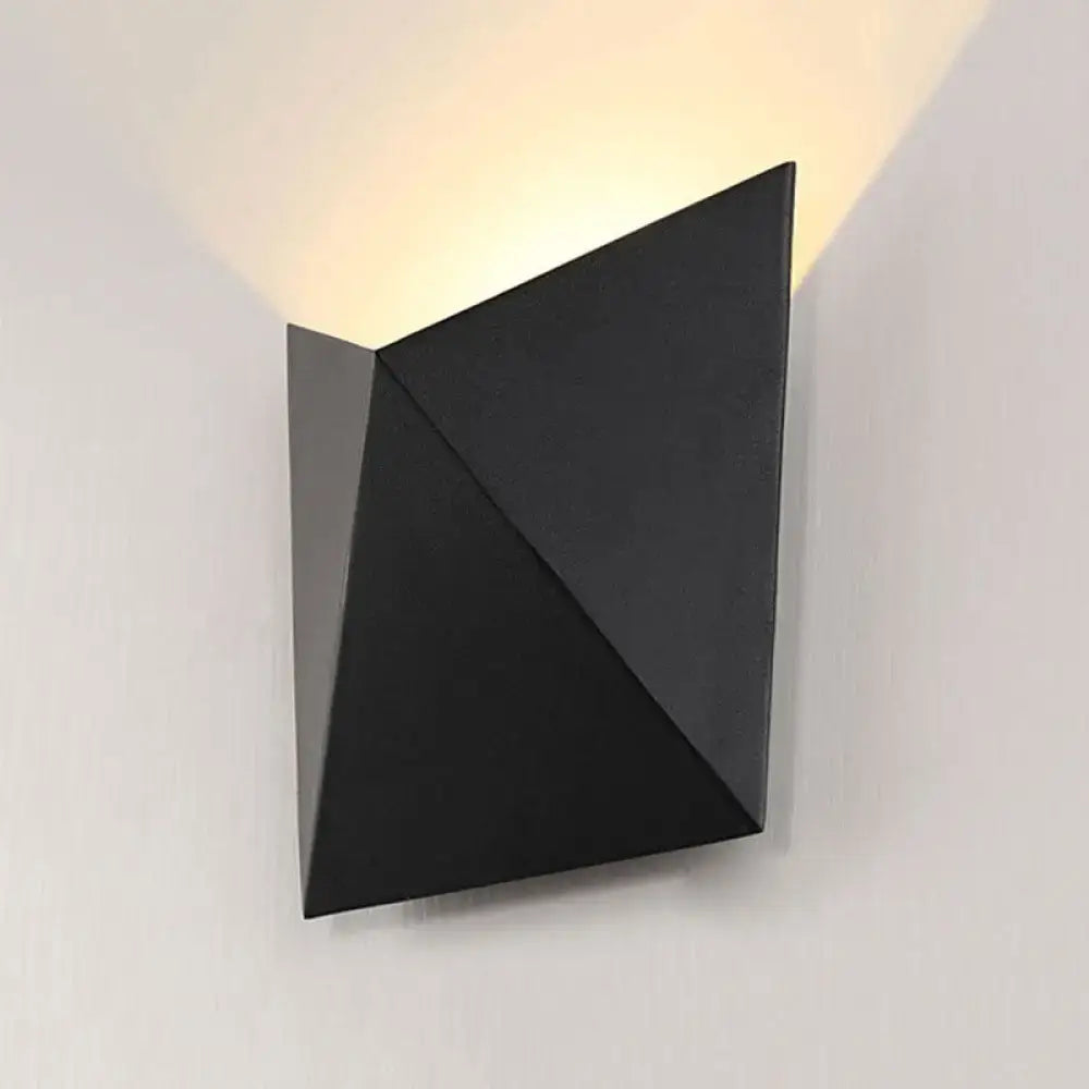Black geometric compact wall sconce with angular facets, modern minimalist design on Tampa Home & Garden Store