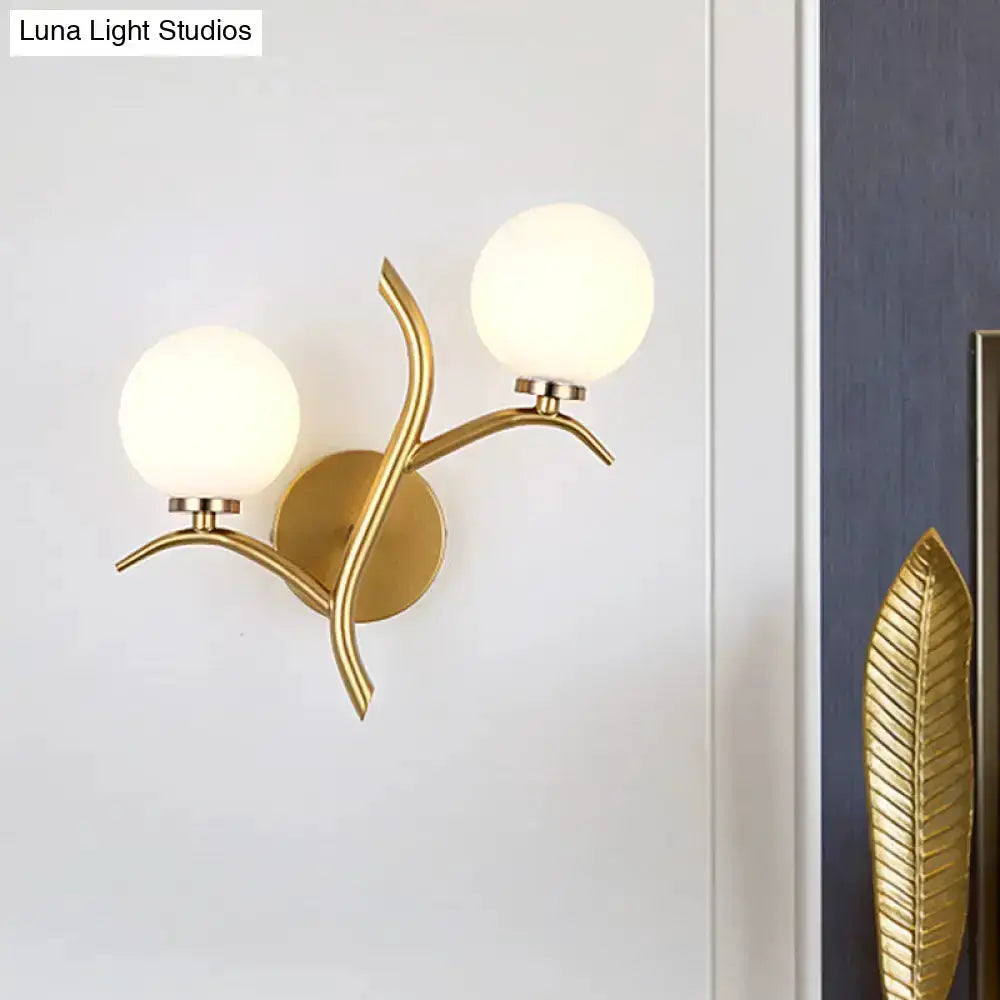 Modern gold branch wall light fixture with two frosted glass globes Decorbites on Tampa Home & Garden Store