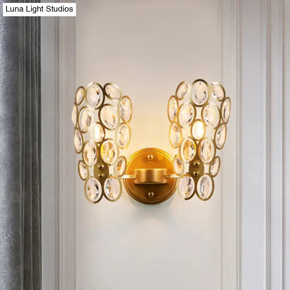 Gold cascading crystal sconce with dual disk clusters on brass backplate wall mount on Tampa Home & Garden Store