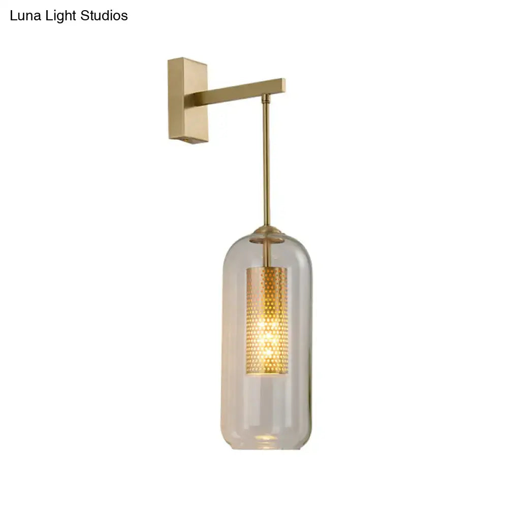 Gold mesh wall sconce with clear glass shade and perforated inner cylinder, brass backplate on Tampa Home & Garden Store