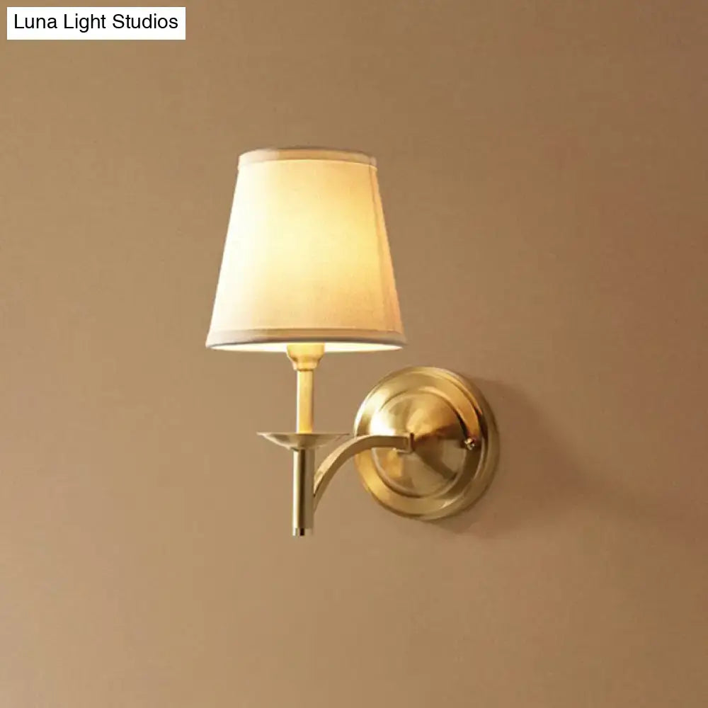Gold Fabric Wall Sconce with brass finish and cream shade, wall-mounted on Tampa Home & Garden Store