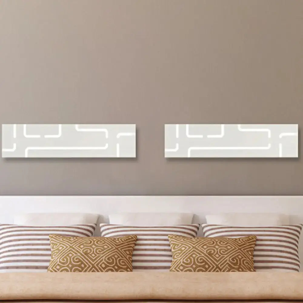 Gray geometric LED wall sconces pair by Decorbites on taupe wall above bed on Tampa Home & Garden Store
