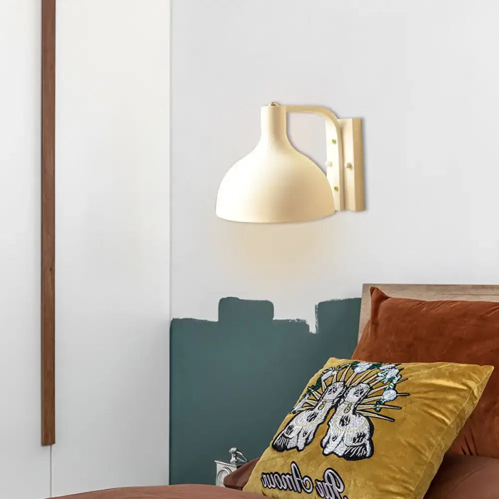 Cream domed wall sconce on brass mounting above teal headboard in bedroom on Tampa Home & Garden Store
