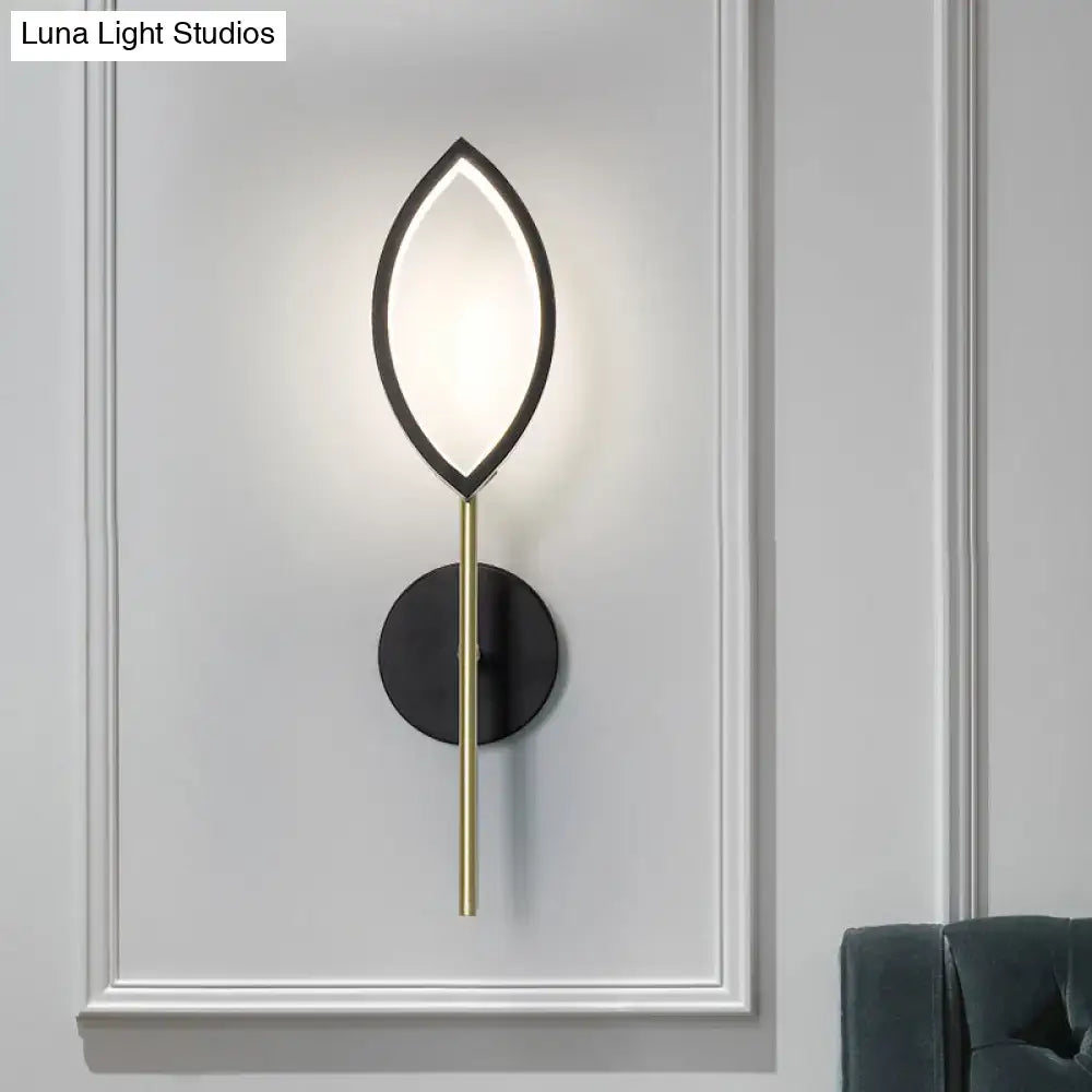 Black gold leaf wall light with illuminated leaf frame and brass stem on black mount on Tampa Home & Garden Store
