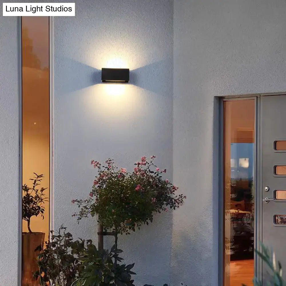 Black rectangle wall sconce by Decorbites, light near entry door on Tampa Home & Garden Store