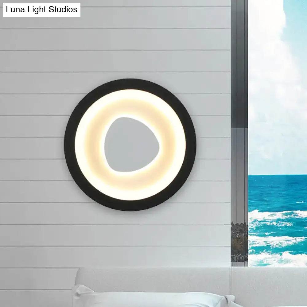 Black Mirror Wall Light with glowing inner ring on a white paneled wall on Tampa Home & Garden Store