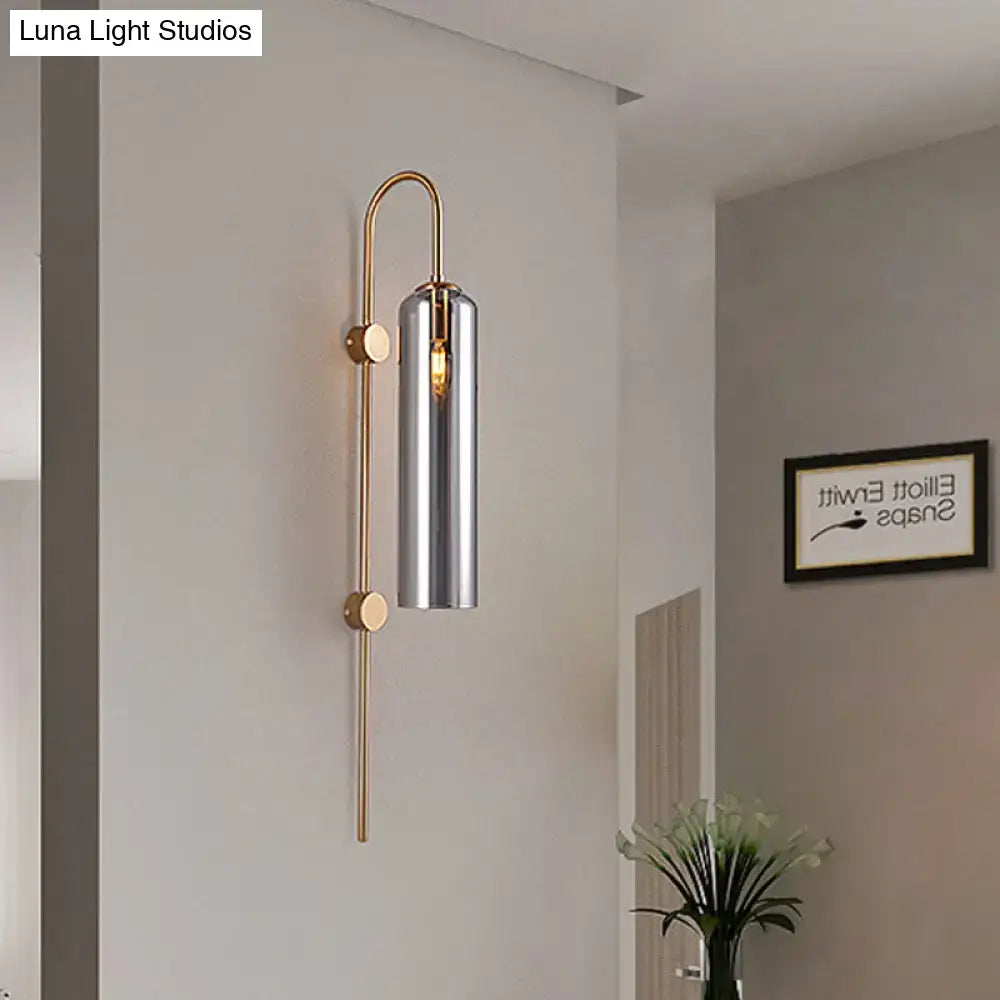 Gray glass cylindrical wall sconce with brass frame and vertical stem Decorbites on Tampa Home & Garden Store