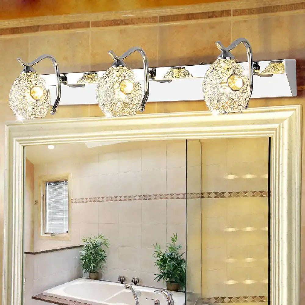 Stainless steel vanity light by Decorbites, chrome, four glass globe shades above mirror on Tampa Home & Garden Store