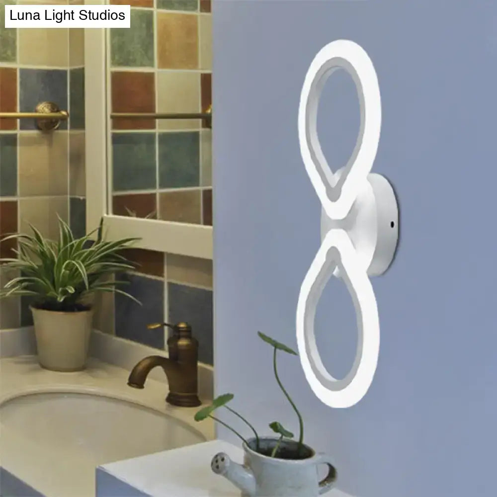 White interlocking ring wall light by Decorbites, modern LED double ring sconce on blue wall on Tampa Home & Garden Store