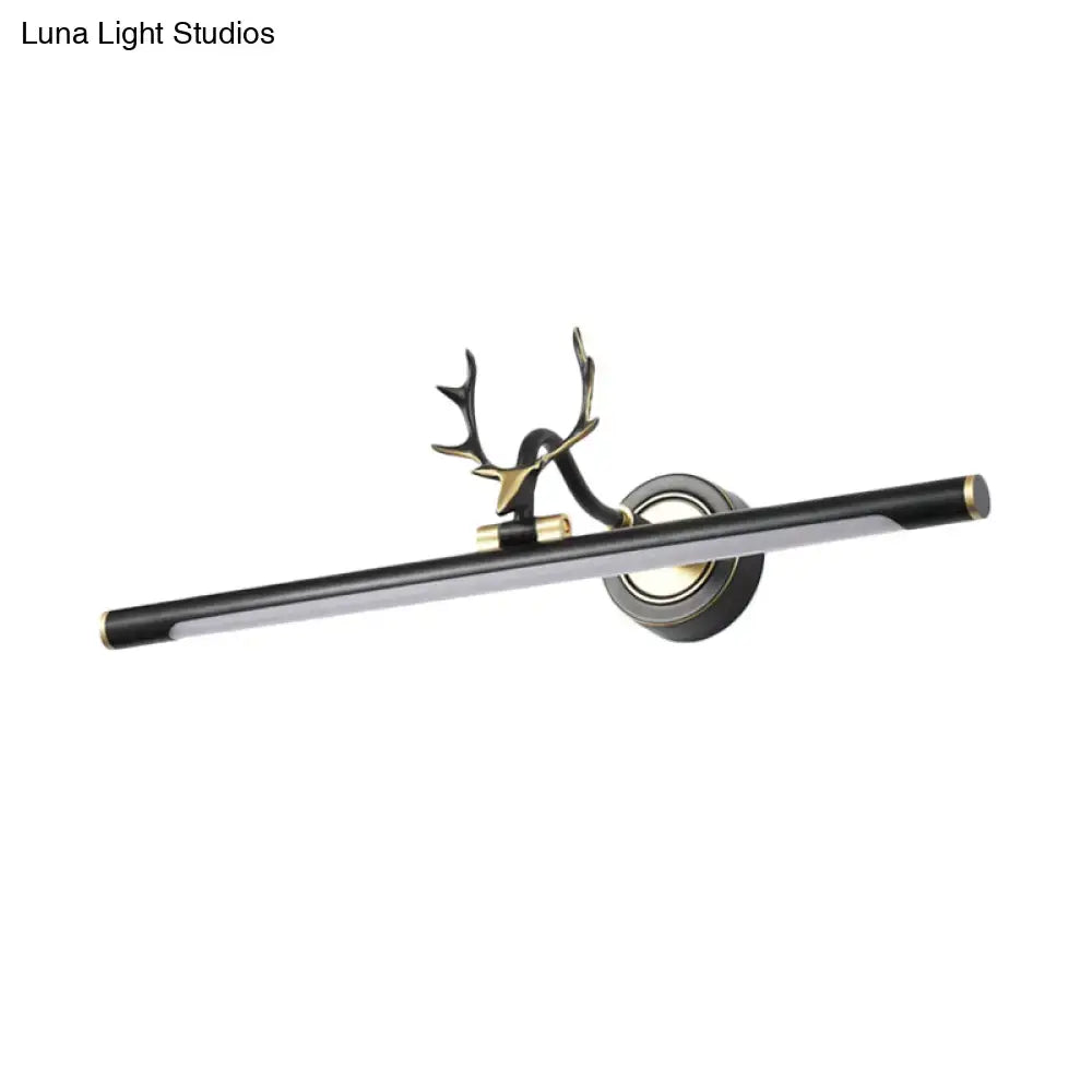Black metal straight shade vanity light with gold end caps and a deer antler mount on Tampa Home & Garden Store