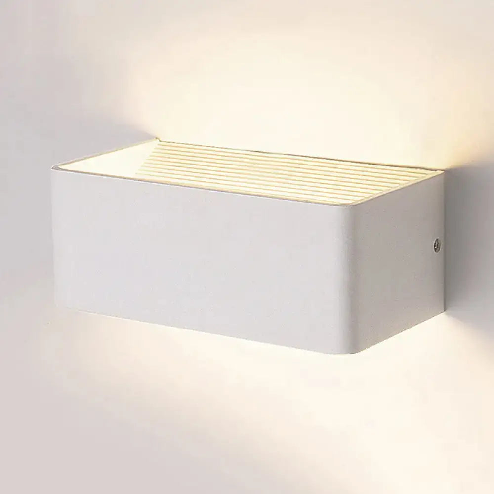 Gold rectangular wall lamp by Decorbites; white metal sconce with ribbed gold top and warm glow on Tampa Home & Garden Store