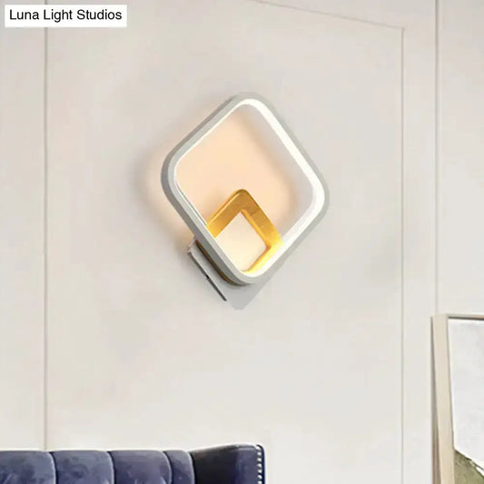White rhombus wall sconce with wood detail and warm LED glow Decorbites on Tampa Home & Garden Store