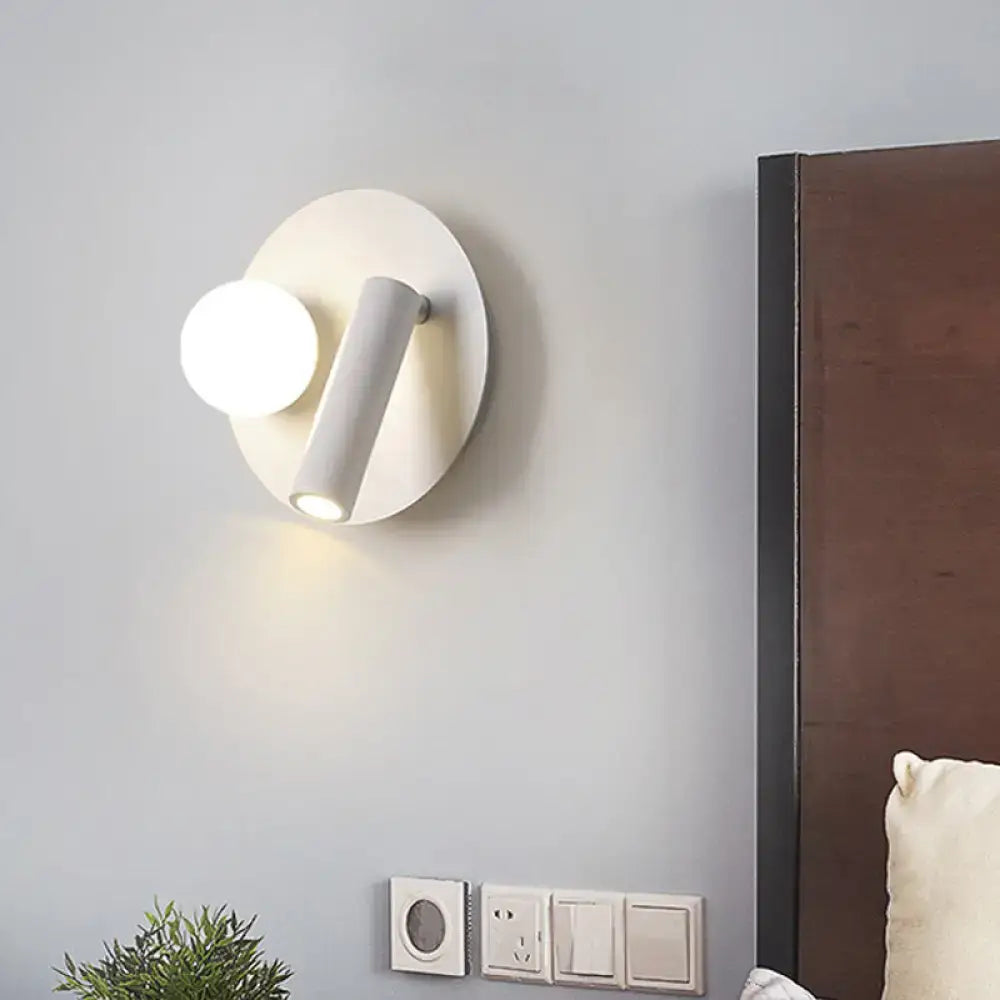 White round wall sconce by Decorbites with circular backplate and angled light tube on Tampa Home & Garden Store