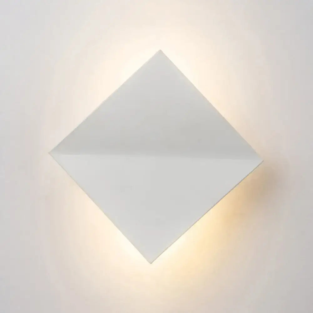 Decorbites white square acrylic wall sconce emitting warm glow on Tampa Home & Garden Store