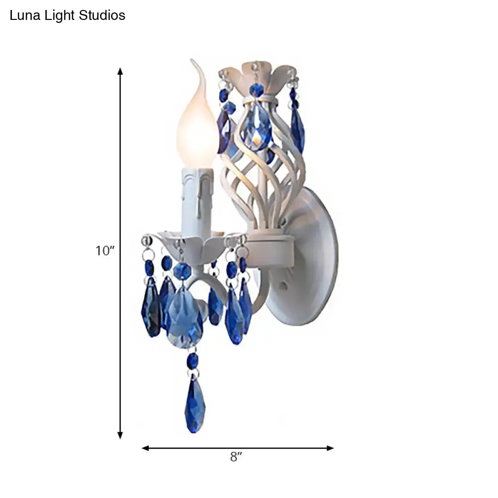 White Crystal Wall Sconce with blue crystal prisms and candle-style bulb on Tampa Home & Garden Store