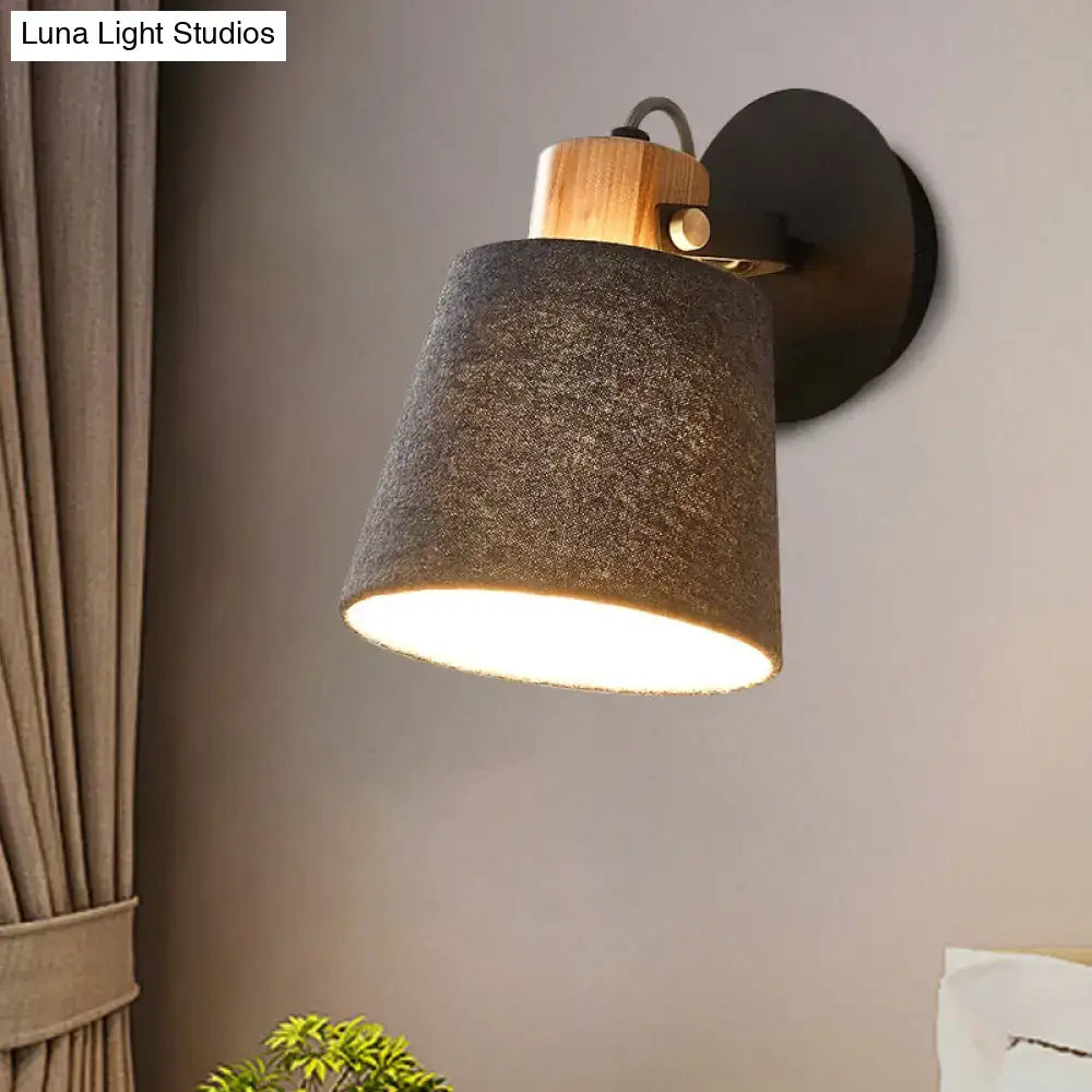Gray fabric wood accent wall lamp with wooden top and black wall mount, warm light on Tampa Home & Garden Store