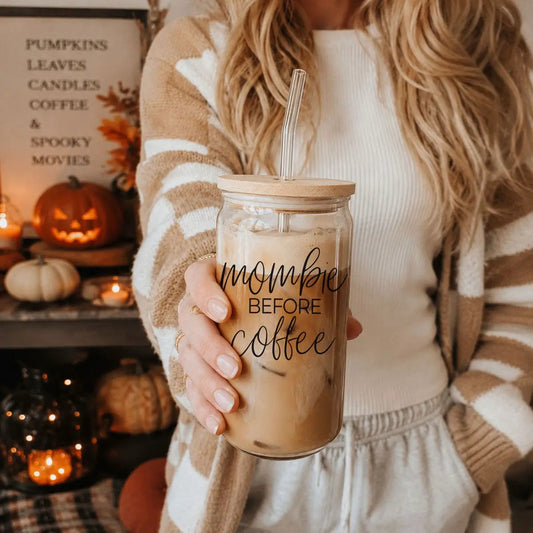 20oz Mombie glass tumbler with straw lid reads before coffee in a cozy fall setup on Tampa Home & Garden Store