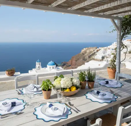 Mykonos placemats with blue trim, set for six on a coastal outdoor table on Tampa Home & Garden Store
