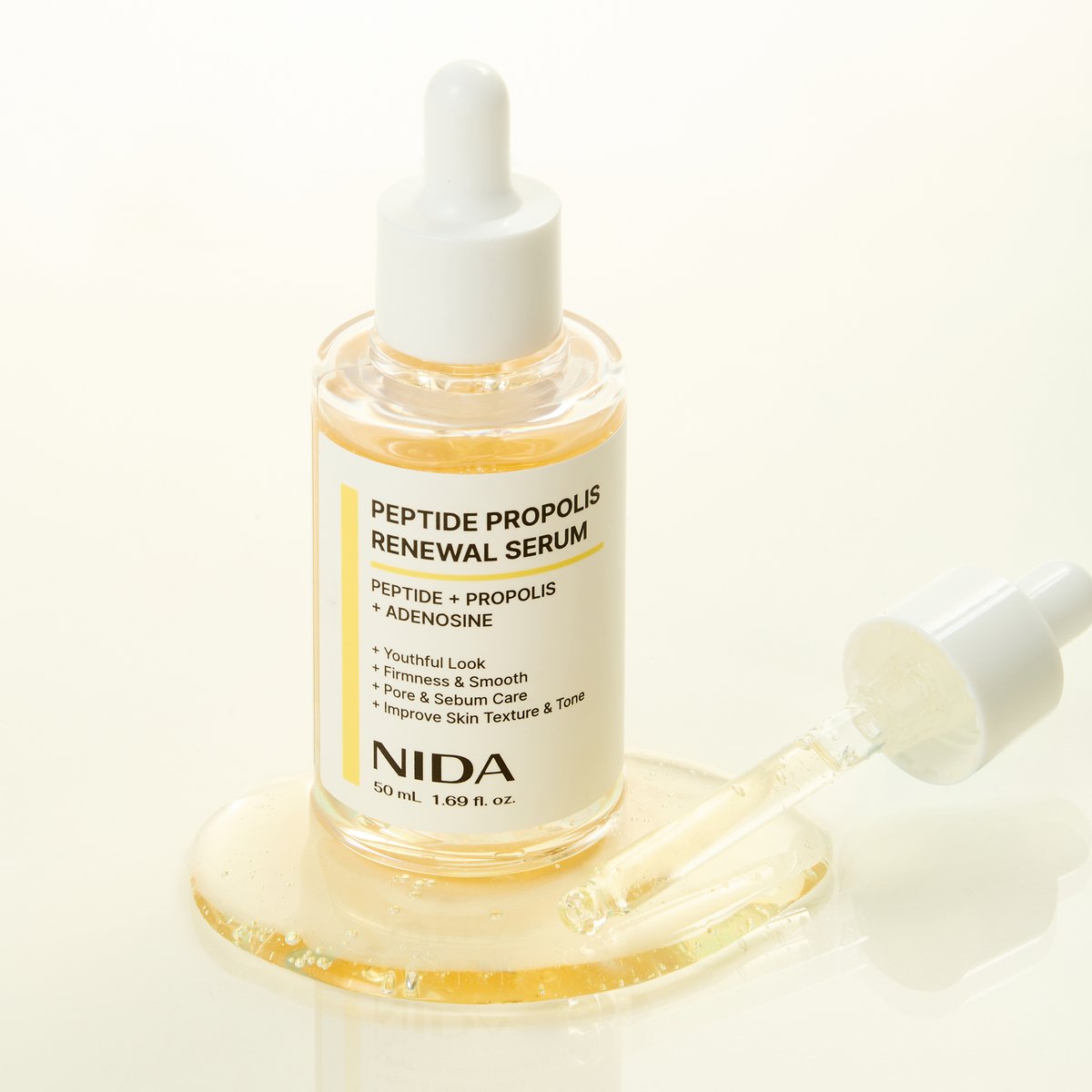 Serum bottle NIDA peptide propolis renewal serum with dropper and yellow liquid, white cap on Tampa Home & Garden Store