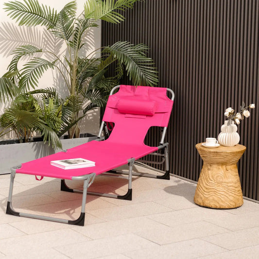 Folding Beach Lounge Chair with Pillow in pink fabric and metal frame, outdoor patio scene on Tampa Home & Garden Store
