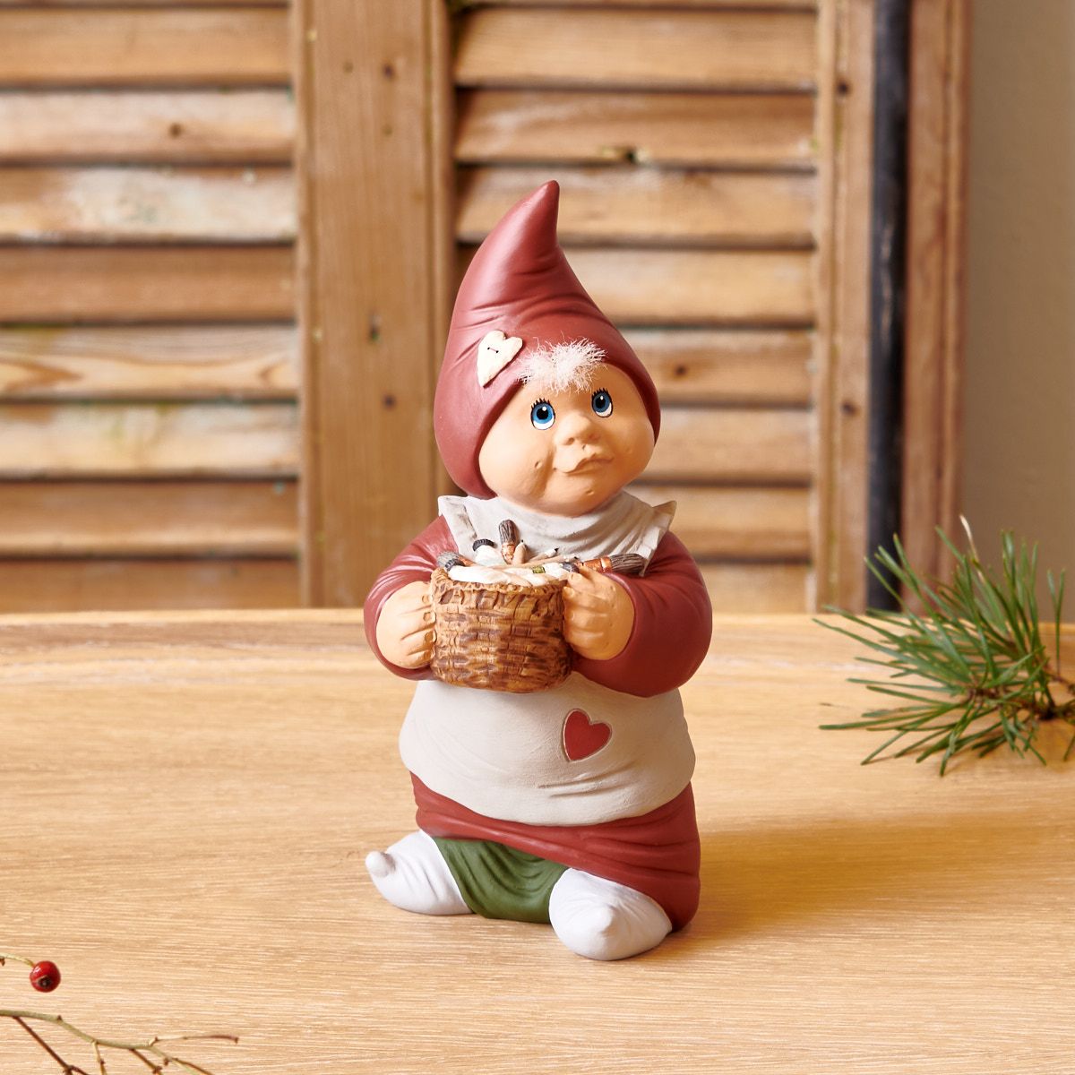 Bette Sonja Klarborg elf figurine 35th anniversary, red hat & apron, holding a basket on Tampa Home & Garden Store