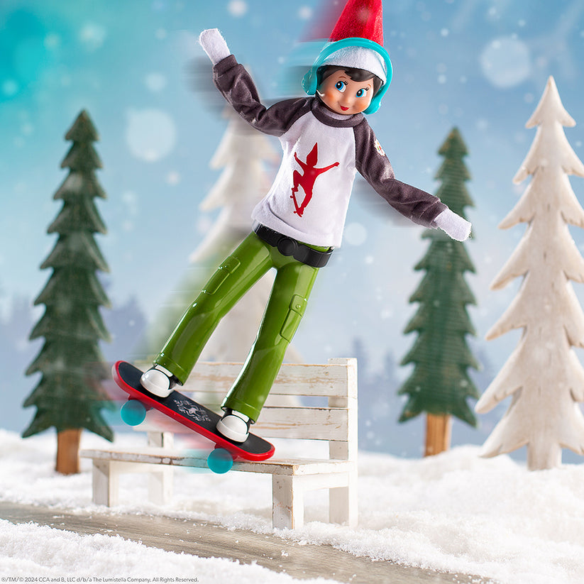 MagiFreez Holly Jolly Ollie plush skateboard with green pants, white top, blue helmet on a bench on Tampa Home & Garden Store