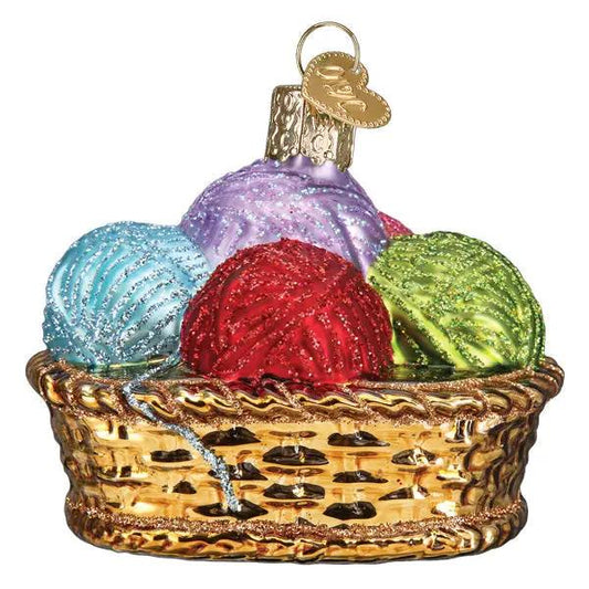 Basket of Yarn Glass Ornament with four multicolor yarn balls in a gold woven basket on Tampa Home & Garden Store
