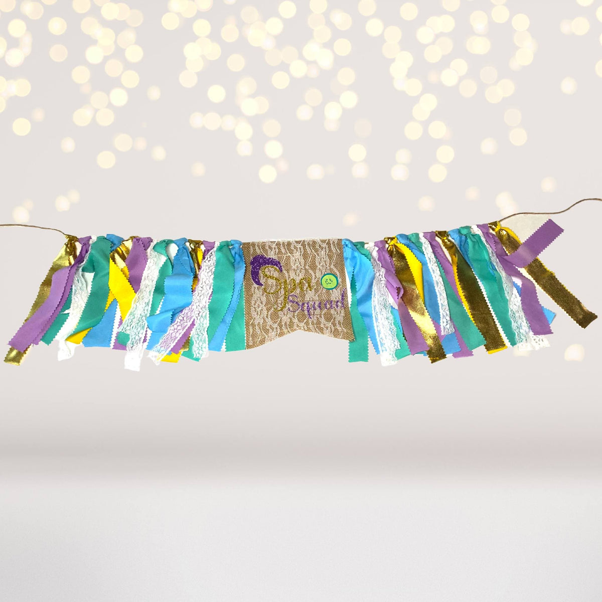 Spa party banner garland with colorful tissue fringe on burlap panel on Tampa Home & Garden Store