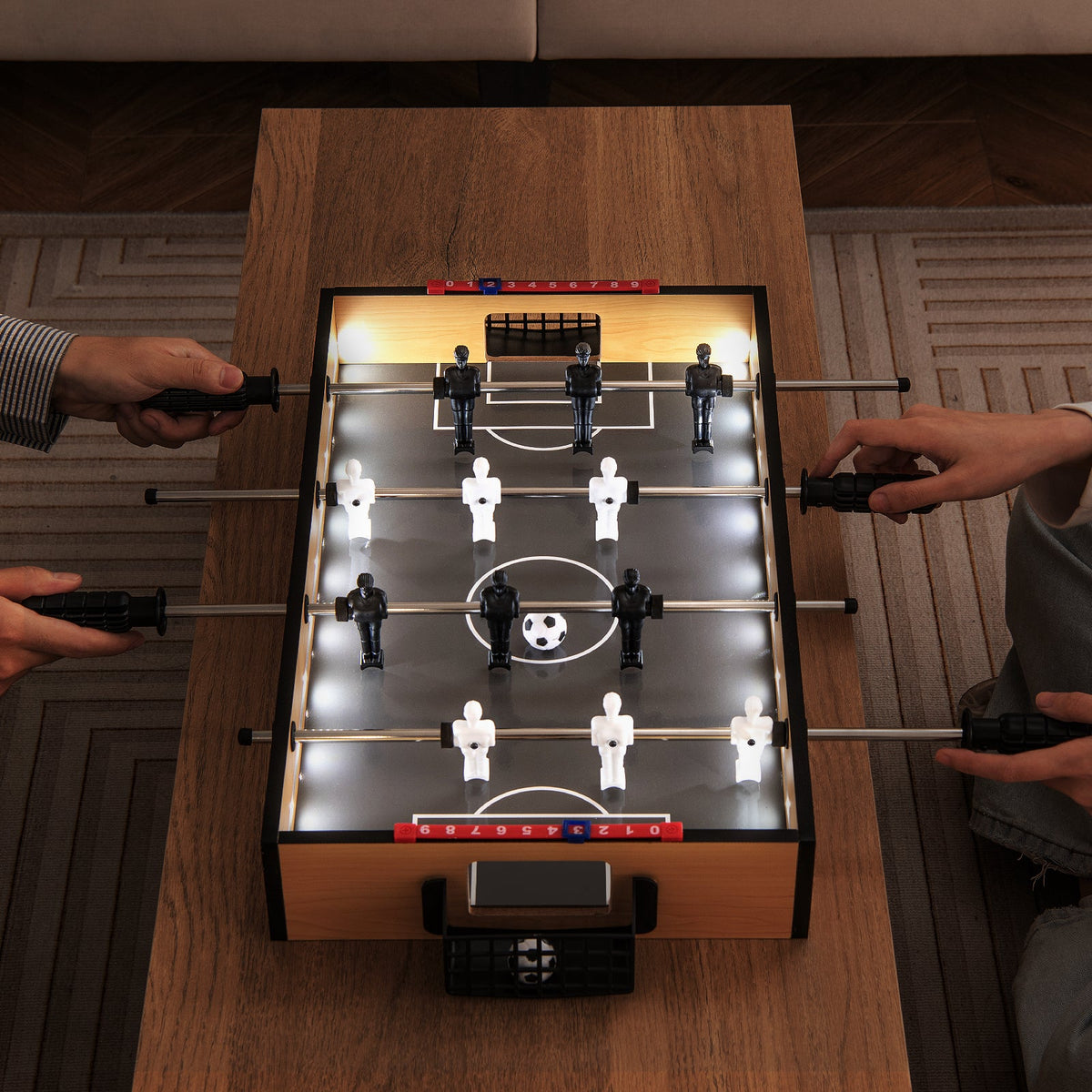 Tabletop foosball table with LED lights and non-slip handles in a wooden cabinet on Tampa Home & Garden Store
