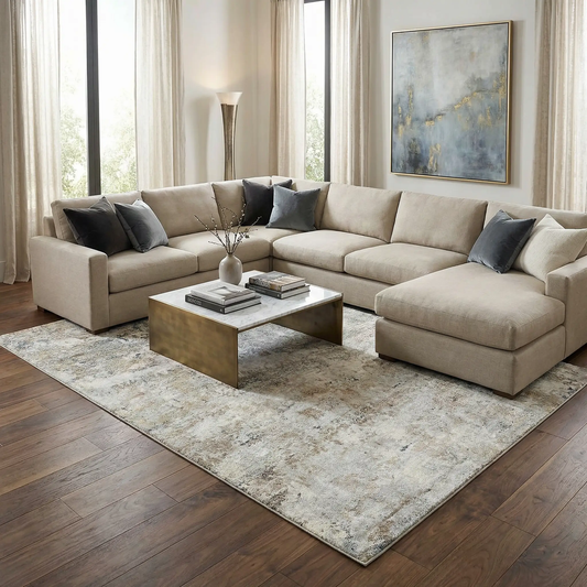 Twyla Thick Luxe Rug by Boutique Rugs, beige-gray abstract pattern under a sectional sofa on Tampa Home & Garden Store