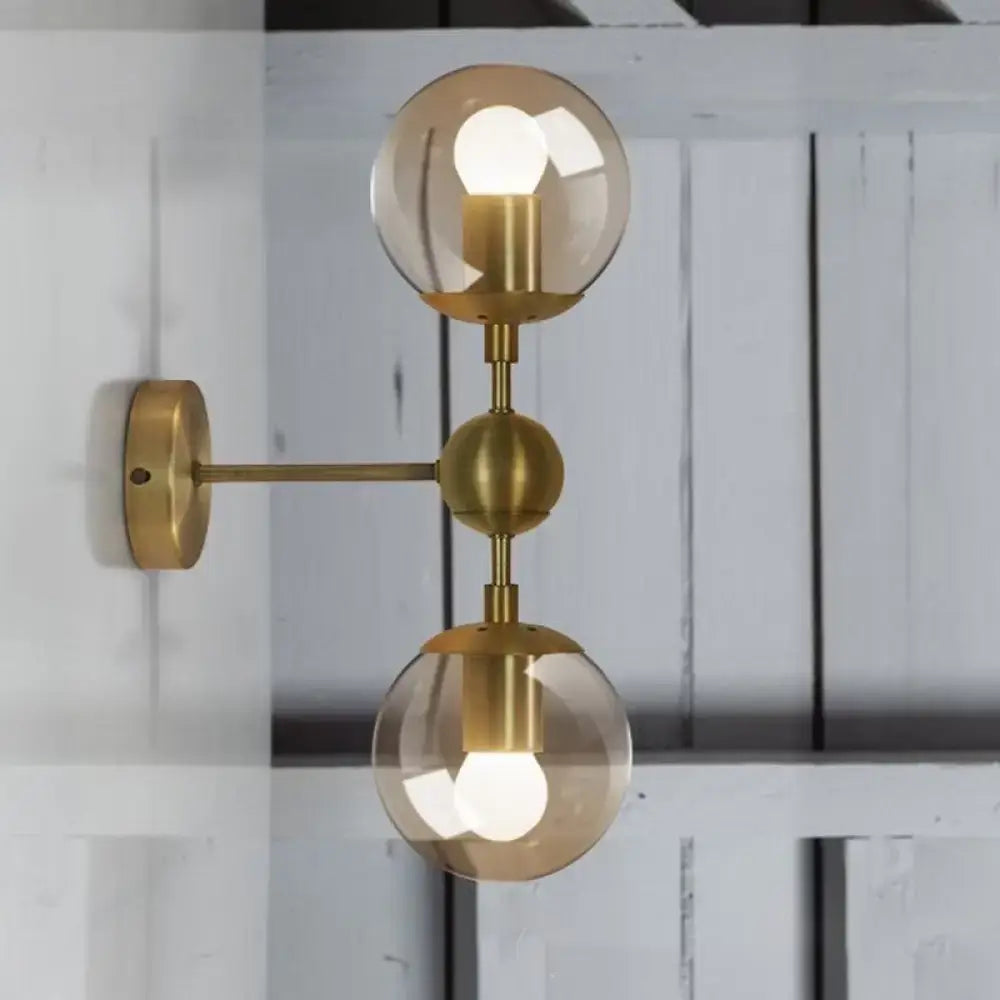 Brass amber globe sconce with dual glass orbs and wall mount by Decorbites on Tampa Home & Garden Store