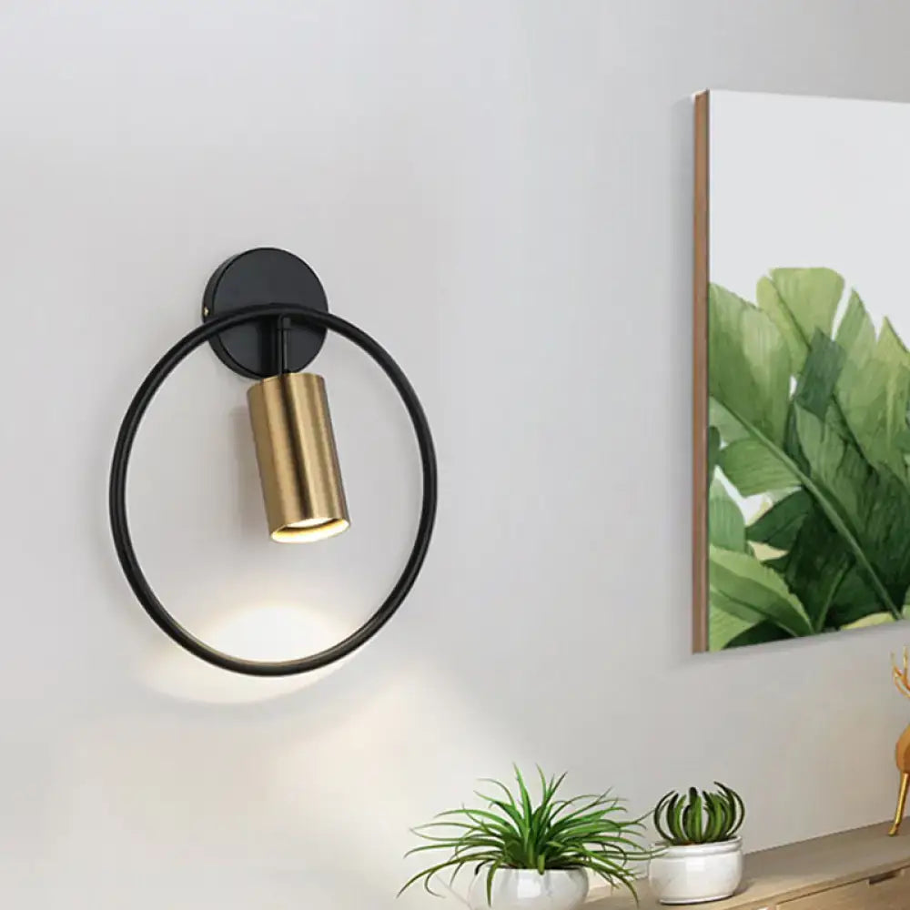 Gold halo ring wall sconce by Decorbites, black circular ring with brass cylindrical light on Tampa Home & Garden Store