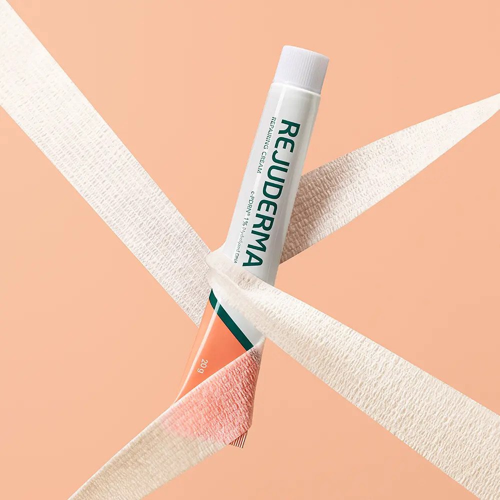 Seoulia REJUDERMA EX Repairing Cream tube in white with typography, 20g, shown with peach box on Tampa Home & Garden Store