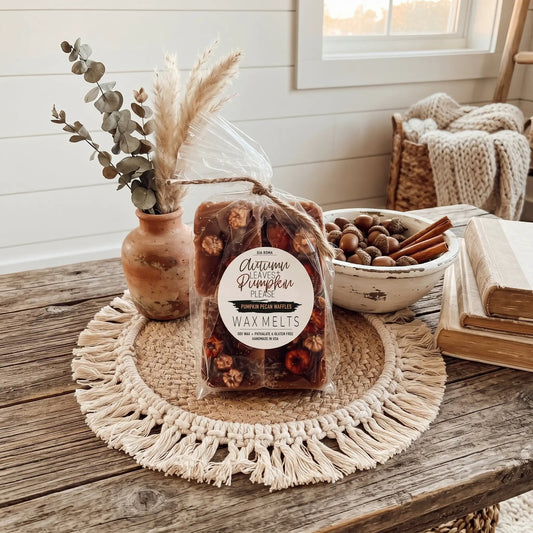 Wax melts Gia Roma Autumn Pumpkin Pecan Waffles in a clear bag with twine beside eucalyptus on Tampa Home & Garden Store
